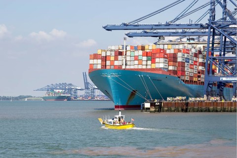 Small foot ferry passenger boat dwarfed by huge Edith Maersk container ship, Port of Felixstowe,