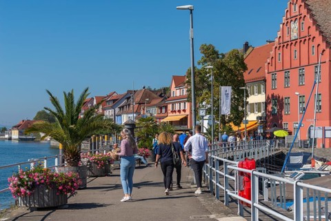 Meersburg on Lake Constance, lakeside promenade, jetty, plant pots, many people, house facades,