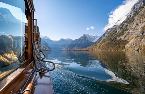 Tourist boat on the Königssee, Watzmann massif, autumnal mountain landscape reflected in the lake,