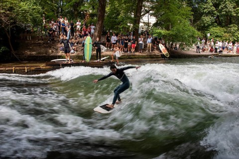 Surfers in the Eisbach, numerous onlookers on the banks, Eisbach wave in the English Garden is