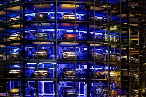 An illuminated car tower with new cars for delivery in the evening, detail, Autostadt, Volkswagen