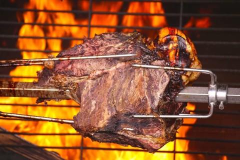 Suckling pig leg on the spit