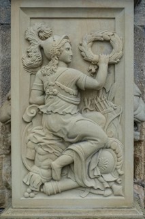 Relief, stone figure, female figure warrior with helmet and wreath at the gate portal, lower castle