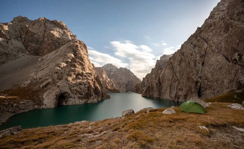 Wild camping, camping in the wilderness with a tent in front of mountain lake Kol Suu, Sary Beles