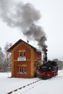 Steam train of the Preßnitztalbahn railway Steam locomotive in winter in Steinbach, Germany, Europe