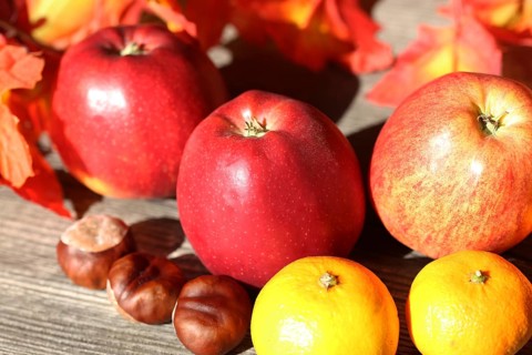 Apples and mandarins on a rustic wooden table as an autumnal motif