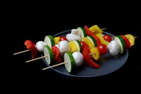 Colourful vegetable skewers on a plate, barbecue skewers