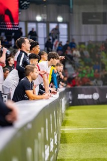 Football players sit on the bench and watch the game, Mercedes Benz Junior Cup, Glaspalast