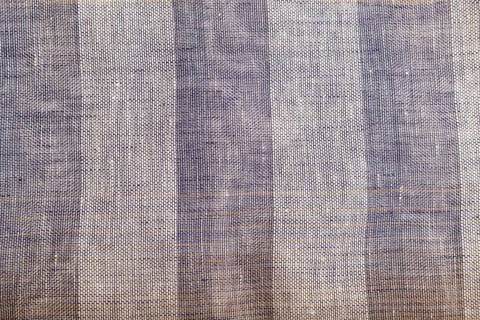 Fragment of smooth brown and violet linen tissue. Top view, flat lay, natural textile background