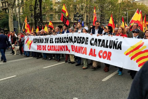 Crowd holding flags and banner with Catalan Senyera, Senera, red and yellow, demonstration, Spanish