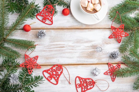 Christmas or New Year frame composition. Decorations, red stars, bells, cones, fir and spruce