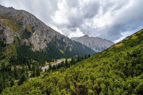 Green mountain valley with river and steep mountain peaks, Chong Kyzyl Suu Valley, Terskey Ala Too,