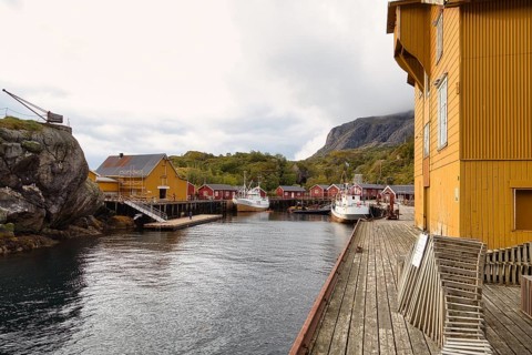 Historic buildings and fishing boats in the harbour of Nusfjord, Lofoten, Nordland, Norway, Europe