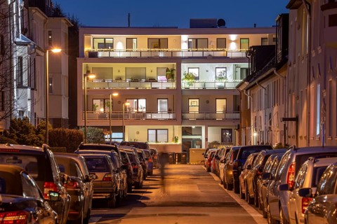 Residential street, many apartment buildings in a residential neighbourhood, evening, lantern