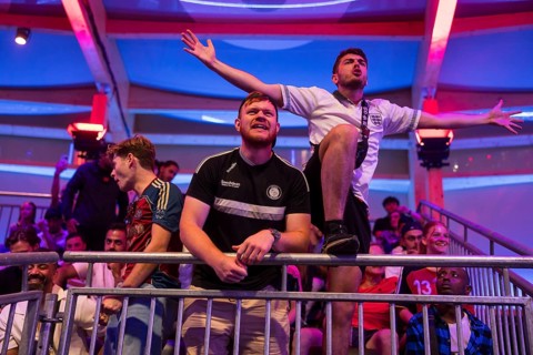 Fans of the British team gesticulate loudly at the Adidas fan zone at the Bundestag during the