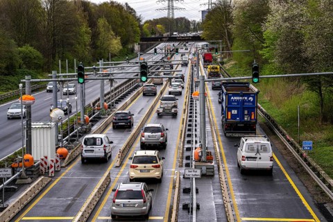 Weighing and barrier system on the A42 motorway, in front of the dilapidated motorway bridge over