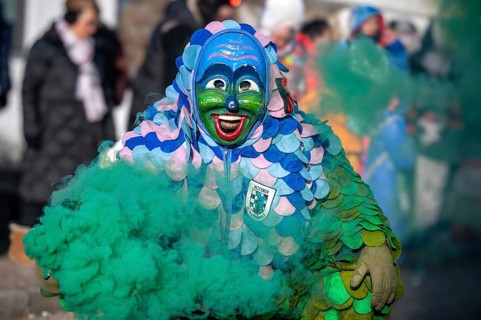 Hofener Scillamännle with smoke bomb at the big carnival parade, Hofen, Stuttgart,