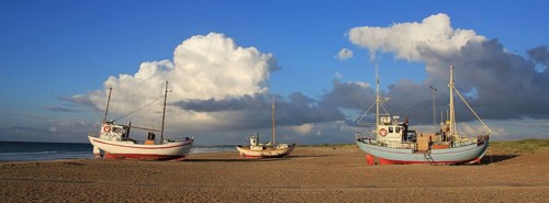 Summer clouds over fishing boats at the Slettestrand, Denmark, Europe