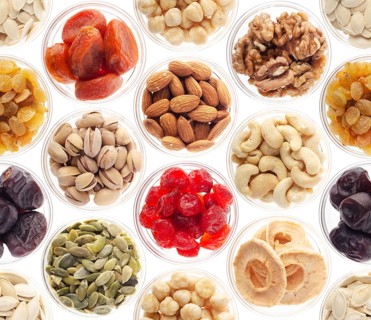 Seamless food background made of nuts, dried berries and dry fruits on white