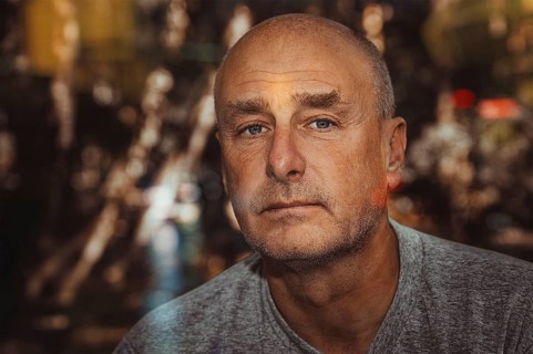 Portrait, man, camera view, beard, unshaven, bald head, background blurred, edge of forest,