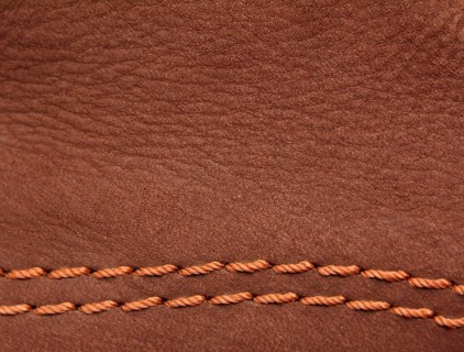 Brown leather suede with sewn seams background