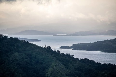 View to the sea over wooded hills, at sunset, cloud forest, Monte Verde, Puntarenas province, Costa