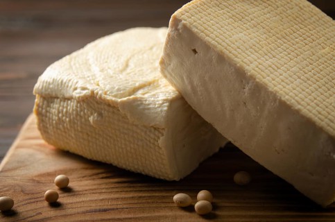 Soybean tofu vegetable bean curd on cutting board on kitchen table