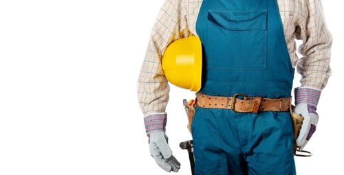 Middle aged contractor in overalls with tool belt holds yellow hard hat in his hands on white