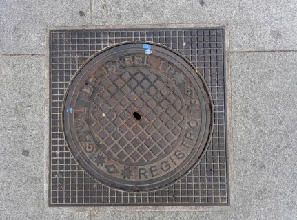 Madrid manhole cover on a busy street in Madrid, Spain, Europe