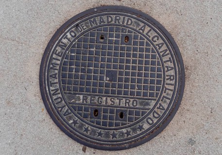 Madrid manhole cover on a busy street in Madrid, Spain, Europe