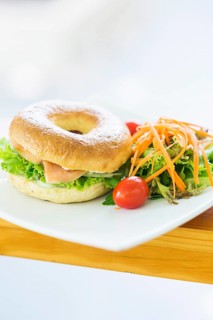 Smoked salmon and cream cheese bagel with salad