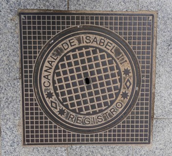 Madrid manhole cover on a busy street in Madrid, Spain, Europe