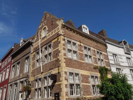 Historic brick houses in a city under a clear blue sky, maastricht. netherlands