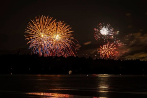 Fireworks over a lake with a reflection in the water