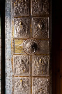 The ornamental metal door entrance to Bhimakali Temple covered in inscriptions and reliefs in
