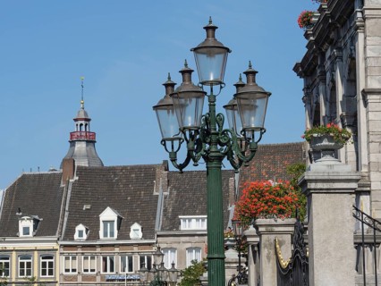 Streetlights and buildings in a historic city with ornate architecture and flowers, maastricht.