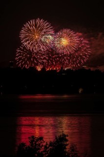 Fireworks over a lake with a reflection in the water