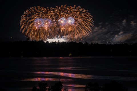Fireworks over a lake with a reflection in the water