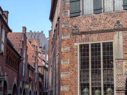 Narrow alley in an old town with historic brick buildings and a window with muntin bars, Bremen,