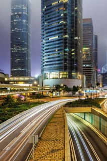 Traffic with streets and skyscrapers in the city of Hong Kong at night in Hong Kong, China, Asia