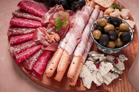Appetizer, assortment, set, sausage, and cheese, on a wooden board, top view, no people