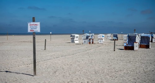 Beach chairs and signs on the sandy beach of the North Sea, Sankt Peter-Ording, Schleswig-Holstein,