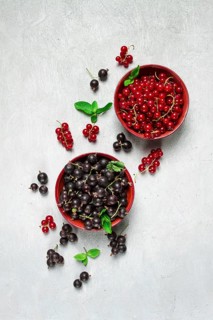 Bowls with berries, black and red currants, top view, food concept, no people