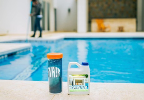 Clarifier for cleaning swimming pools. Clarifying chemical at the edge of a swimming pool