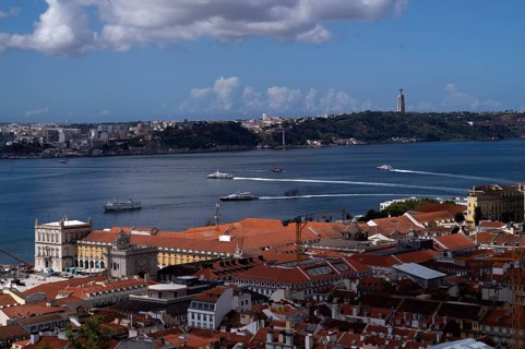 View from Castelo de São Jorge to old town, city view, river Rio Tejo with ferries, ferry boats,