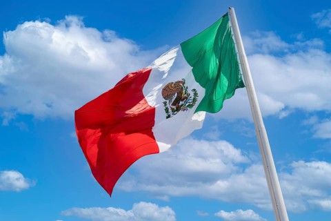 Los Cabos San Jose Del Cabo, Mexico, Mexican tricolor national striped flag proudly waving at mast,