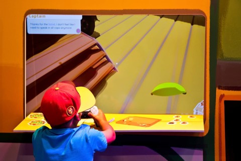 Child in front of a screen with a computer game, Gamescom trade fair, the world's largest trade