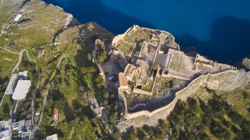 Drone shot, Acropolis of Lindos, late afternoon light, view from above of a historic fortress on