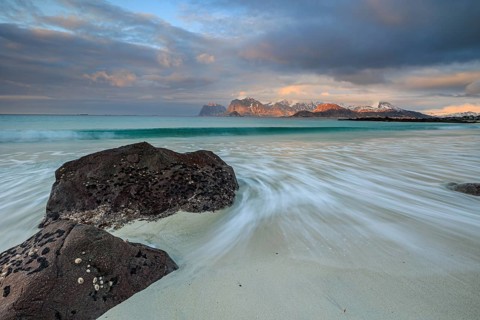 Rocks and beach in front of Bergen, sea, surf, spray, clouds, winter, Flakstadoya, Lofoten, Norway,