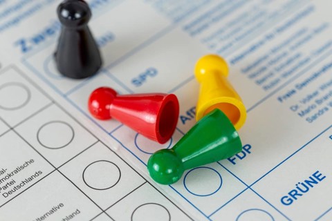 Symbolic image of poll results and election results in Germany: Overturned game pieces in the